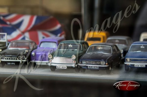 antique toy cars in a store window in france