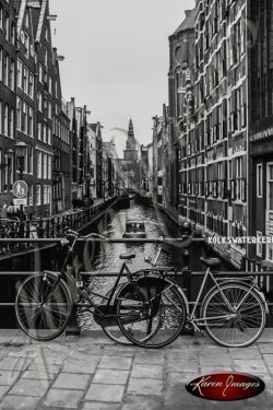 bike locked to canal guard black and white amsterdam holland