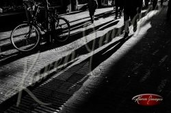 Black and white of brugge belgium shadows of anonymous people walking