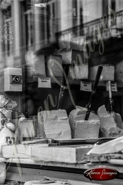 Black and white of cheese in a store window