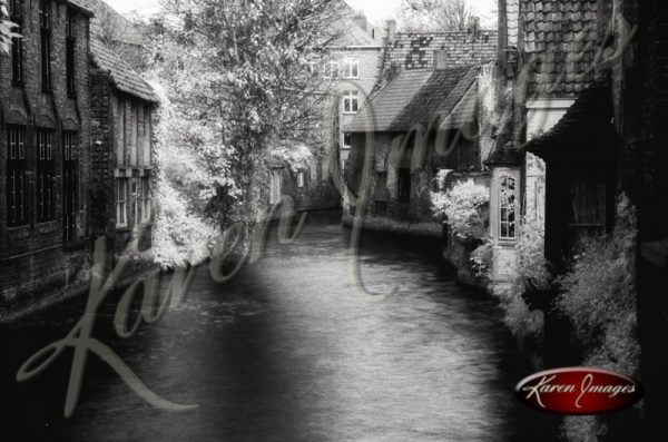 Black and white of brugge belgium canal with brick homes