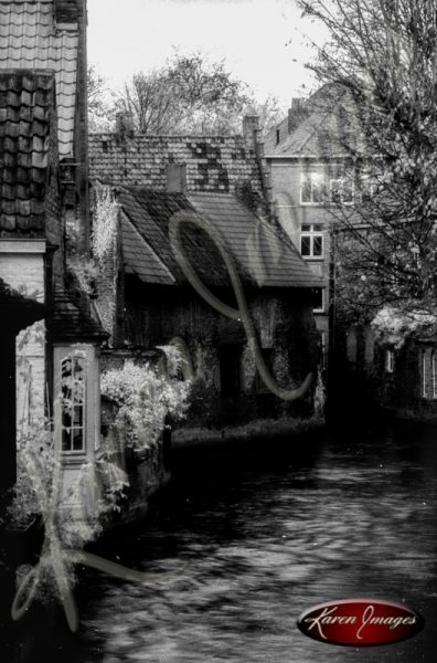 Black and white of brugge belgium canal with brick homes