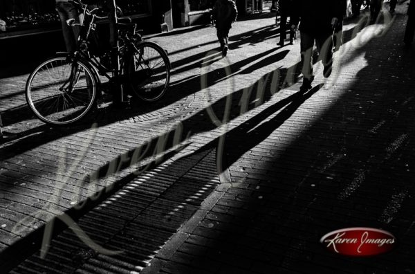 Black and white of brugge belgium shadows of anonymous people walking